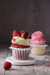 red velvet cupcake with raspberries and cream