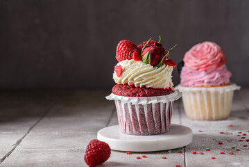 red velvet cupcake with raspberries and cream