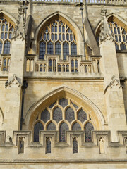 Fototapeta na wymiar Bath Abbey England UK Stained glass and bath stone detailing with butresses