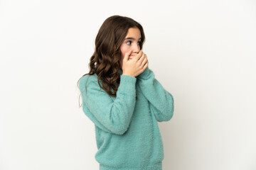 Little caucasian girl isolated on white background covering mouth and looking to the side