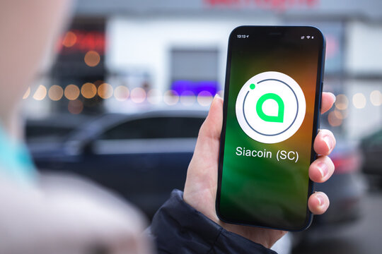 Siacoin SC symbol. Trade with cryptocurrency, digital and virtual money, mobile banking. Hand with smartphone, screen with crypto icon close-up photo