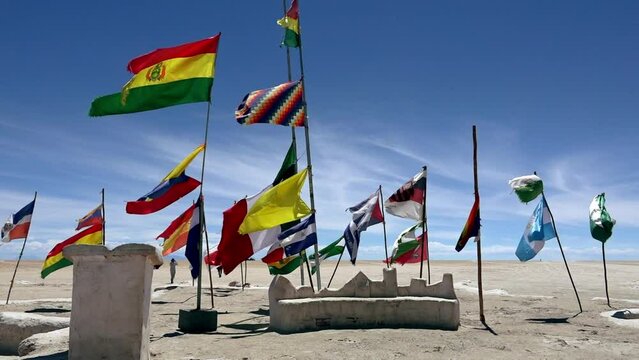 Flags of countries in Dakar Rally flying in the wind at Salar de Uyuni, Bolivia