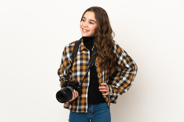 Little photographer girl isolated on background posing with arms at hip and smiling