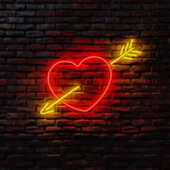 Neon heart and arrow on a brick wall