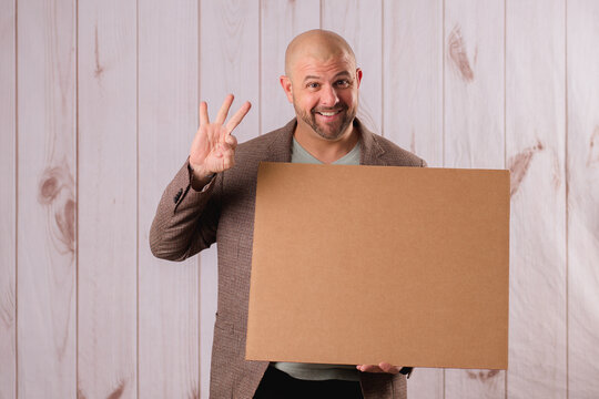 business man holding up a cardboard sign blank making gestures and faces 