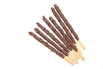 Chocolate mixed biscuit stick isolated on white background. crispy sweet straws filled chocolate with crushed nuts. top view