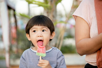 Little asian boy eating ice cream