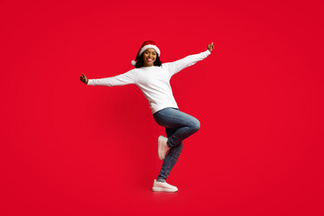 Carefree pretty black lady moving on red background
