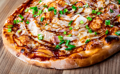 Pizza with chicken and barbeque sauce . Italian pizza on wooden table background