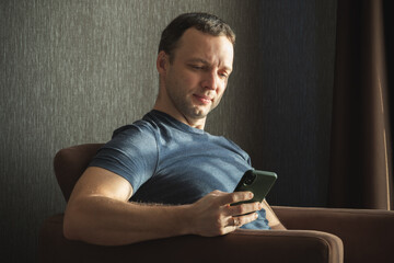 Portrait of European man sitting with a smartphone