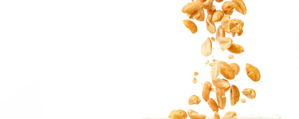 Peanut kernels falling with white background and copy space.
