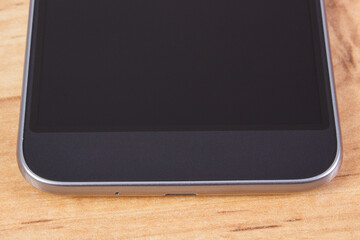 Mobile phone with blank screen on table, smartphone