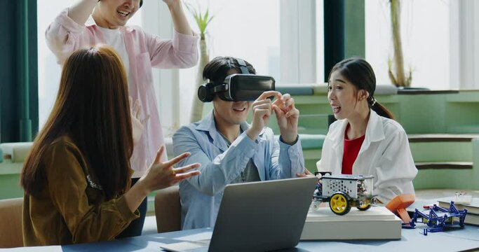 Group of Asian businessmen hold meeting to test VR glasses technology in co-working space. Collaboration of startup business team. learning innovation of meta verse technology of model electric car