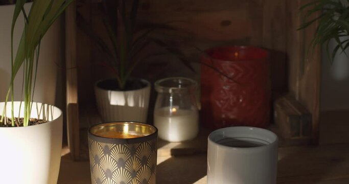 Flower pots and candles on the ground, medium shot