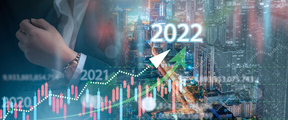Double exposure of businesswoman with cityscape and financial graph on blurred building background, Business Trading concept , business growth direction and investor trends in 2022