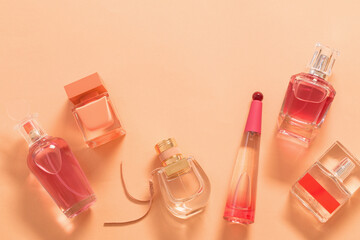 group of perfume bottles on orange background