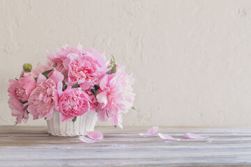 bouquet of pink flowers in a basket