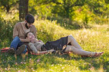 the couple is resting in nature, the girl lies on the guy