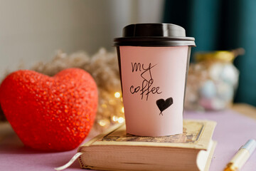 Cup of coffee and open notebook on table