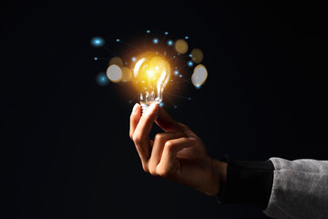 Hand of holding illuminated light bulb, idea, innovation inspiration concept