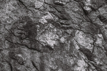 Horizontal black and white colors photography of real stony textured surface of mountain. Abstract flat lay texture of stones