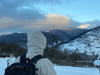 Fototapeta na wymiar Man photographer waching on mountain in winter 