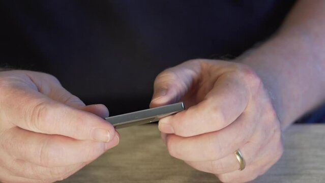 Men's hands open and showing a USB stick