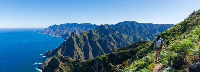 Woman hiker watching beautiful costal scenery. - Tenerife, Canary Islands, Spain. coast view, mountain Anaga