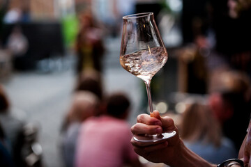 wine glass in the male sommelier's hand. Wine bar or winery. degustation.