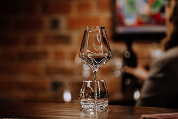 wine glasses and bottles of wine in the entourage of the wine bar in the evening