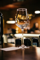 wine glasses and bottles of wine in the entourage of the wine bar in the evening