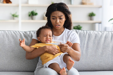 High Fever. Concerned Black Mom Checking Temperature Of Her Crying Infant Baby - Powered by Adobe