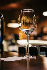 wine glasses and bottles of wine in the entourage of the wine bar in the evening