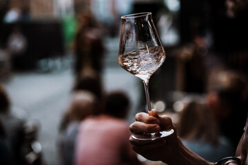 wine glass in the male sommelier's hand. Wine bar or winery. degustation.