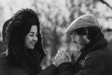 Couple together in winter park having fun