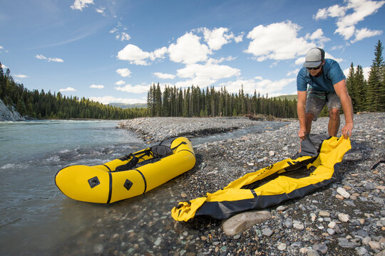Paddler rolls out inflatable packraft before a day of paddling.