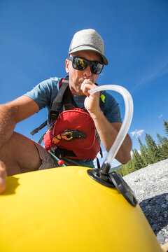 Man Uses Straw Tube And Lungs To Inflate Packraft