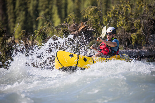 Paddler navigates exciting whitewater rapids.
