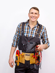 Happy technician in uniform over white background. Electrician with standard equipment
