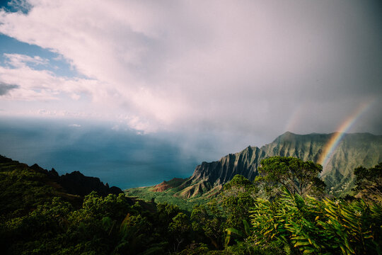 Rainbow falls over the Kalalau Valley in Kauai's Nā Pali Coast