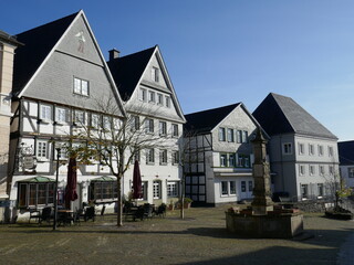 Historic row of houses on the old market of Arnsberg, Sauerland, North Rhine-Westphalia, Germany, on the right the Maximilianbrunnen (Maximilian fountain)