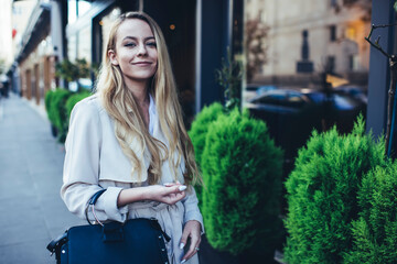 Delighted young woman looking at camera