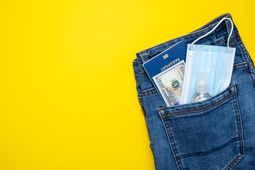 Pocket with jeans passport money and protective mask. Pandemic travel concept.