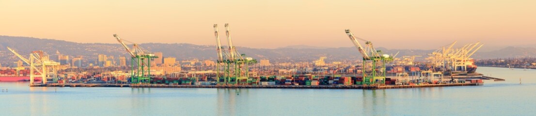 Sunset over Port of Oakland with Oakland in the background.
