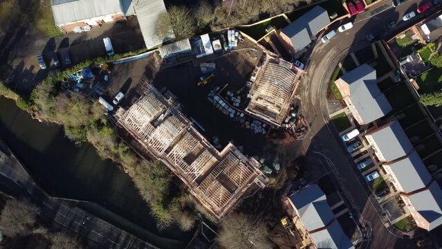 Aerial view of British housing development with roof trusses and materials