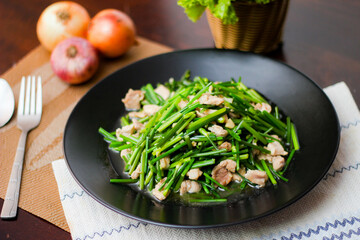 Stir-fried morning glory in a black dish 