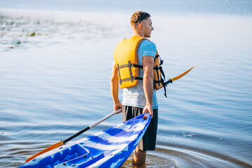 Young man kayaking on the river
