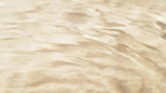 Super slow motion of water waves with sand texture. Filmed on high speed cinema camera, 1000 fps.