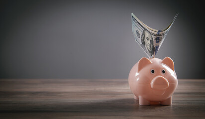 Piggy bank and money on the desk. Saving. Business