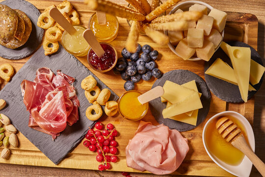 Wooden Cutting Board With Cold Cuts And Cheeses